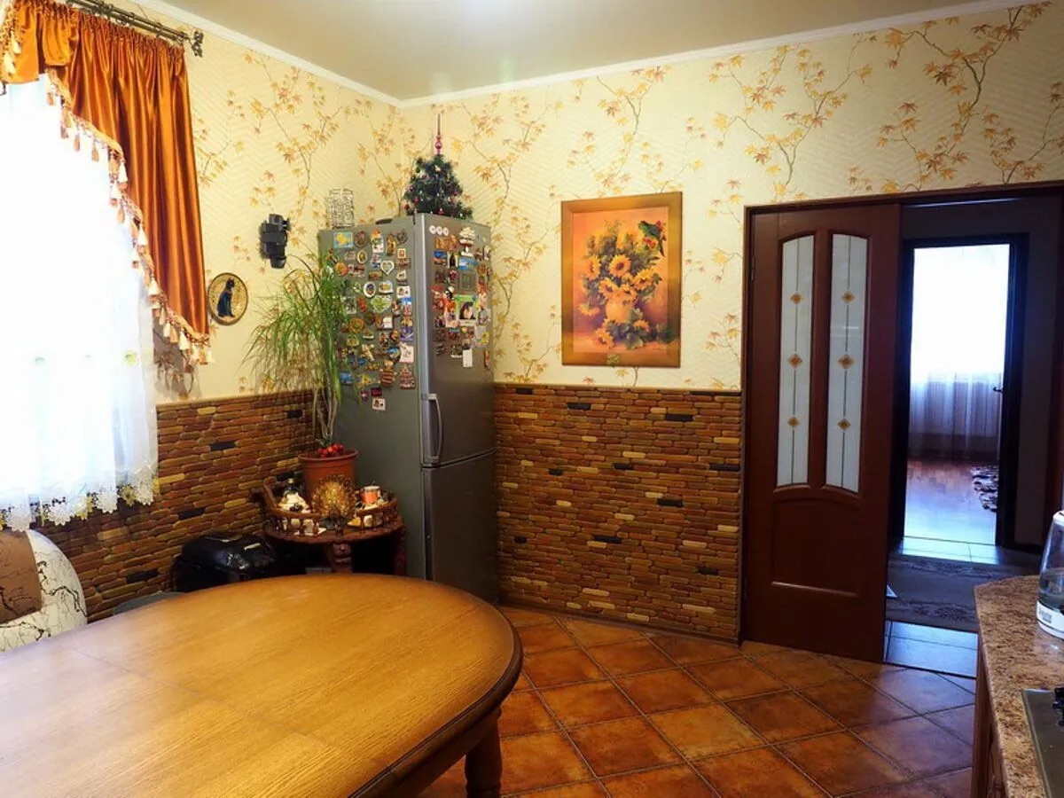 Кухня с декоративной тарелкой с изображением кота на стене.